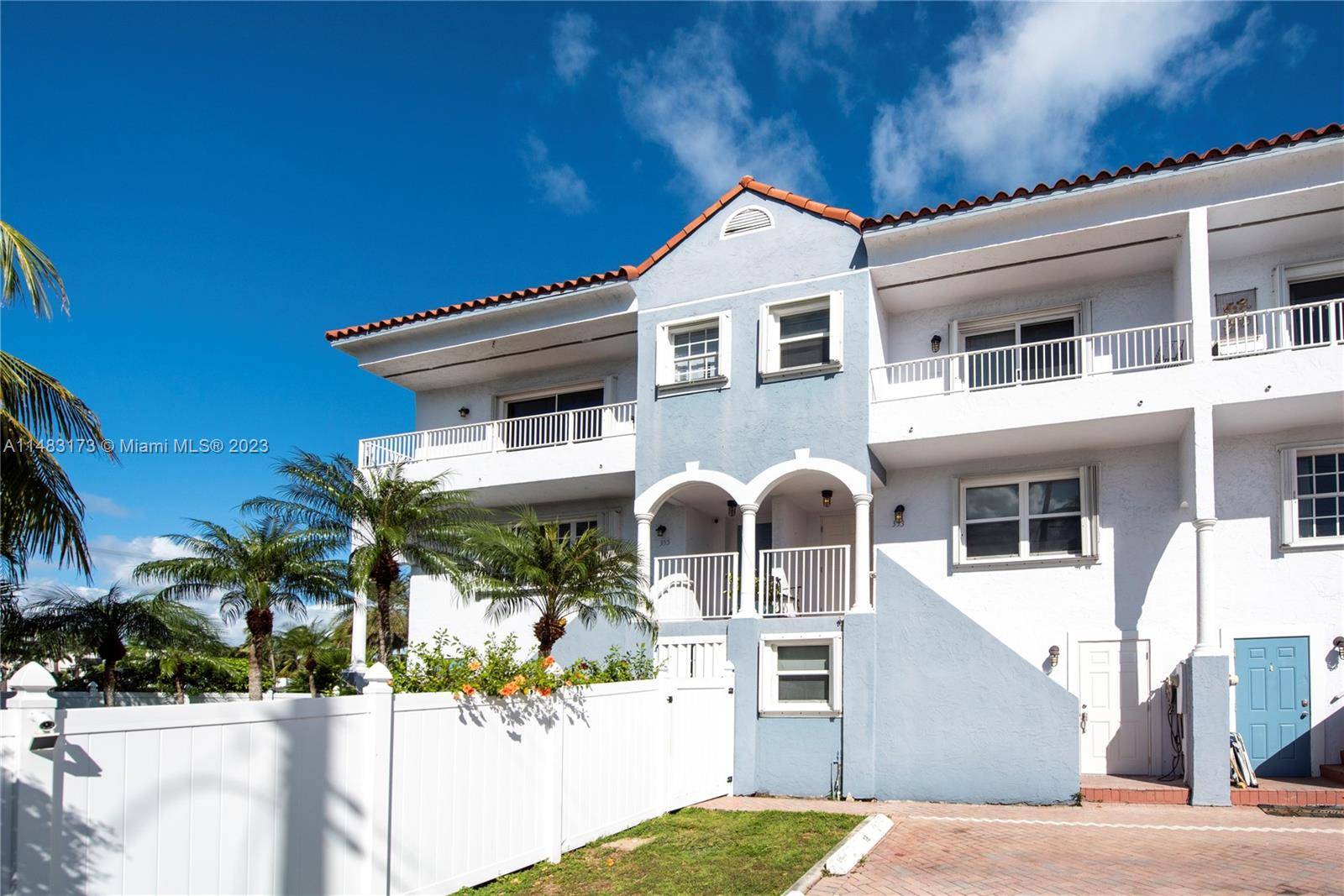 Stunning beachside townhome with three bedrooms, three bathrooms, and an open den area.