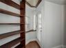 Record room or library with built-in wooden shelves & two built-in desks.