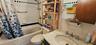 Full bathroom featuring shower / tub combo with curtain, vanity, and tasteful backsplash
