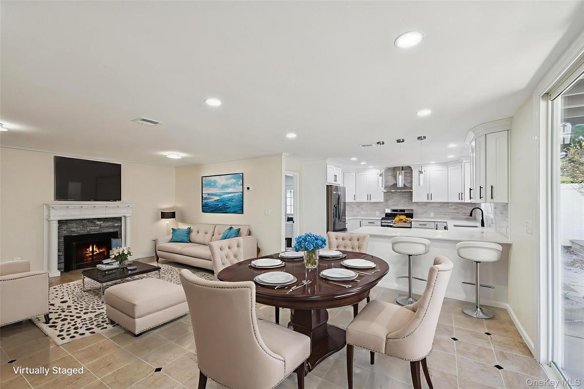 Open-concept living space featuring a dining area, kitchen, and living room