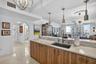 Spectacular kitchen w/ custom bleached walnut veneer cabinetry by renowned Chicago based millworker. Grain matches from top to bottom. Taj mahal quart