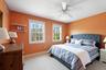 Bedroom with light carpet and ceiling fan