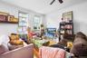 Living room featuring crown molding, wood finished floors, and a ceiling fan