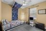Secondary bedroom with vaulted ceiling and ceiling fan.