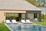 Rear view of house with an outdoor living space, a patio, an outdoor pool, a storage structure, and an outdoor structure
