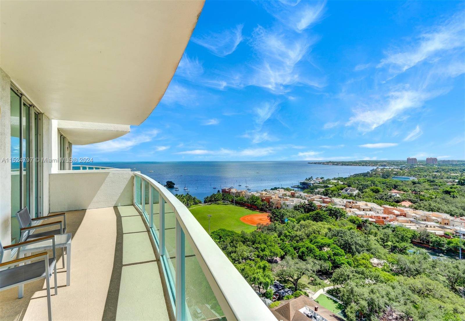 Spectacular bay views from this stunning corner residence w wrap around balcony in Arya, a full service luxury condo hotel in the heart of the Coconut Grove.