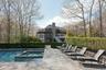 View of pool featuring a patio, a pool with connected hot tub, and stairway