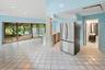Kitchen with appliances with stainless steel finishes, light tile patterned flooring, vaulted ceiling, recessed lighting, and light countertops