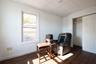 Living area featuring dark wood-type flooring and a paneled ceiling