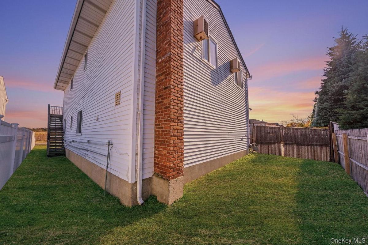 View of property exterior featuring stairway and a fenced backyard
