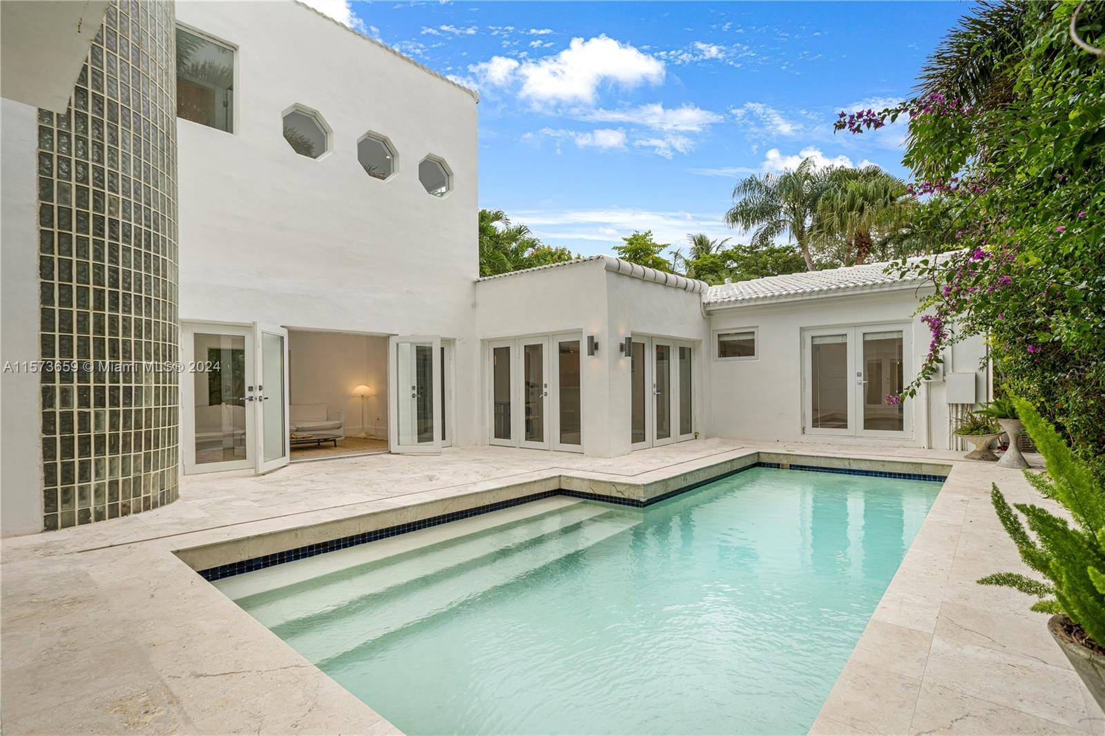Multilevel home with St Barts villa vibes in a serene Coconut Grove location.