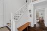 Staircase with hardwood / wood-style flooring and baseboards
