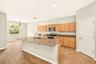 Spacious kitchen featuring stainless steel appliances, large island, granite countertops and an eat in dining area