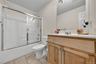 The guest bathroom has a tub/shower.