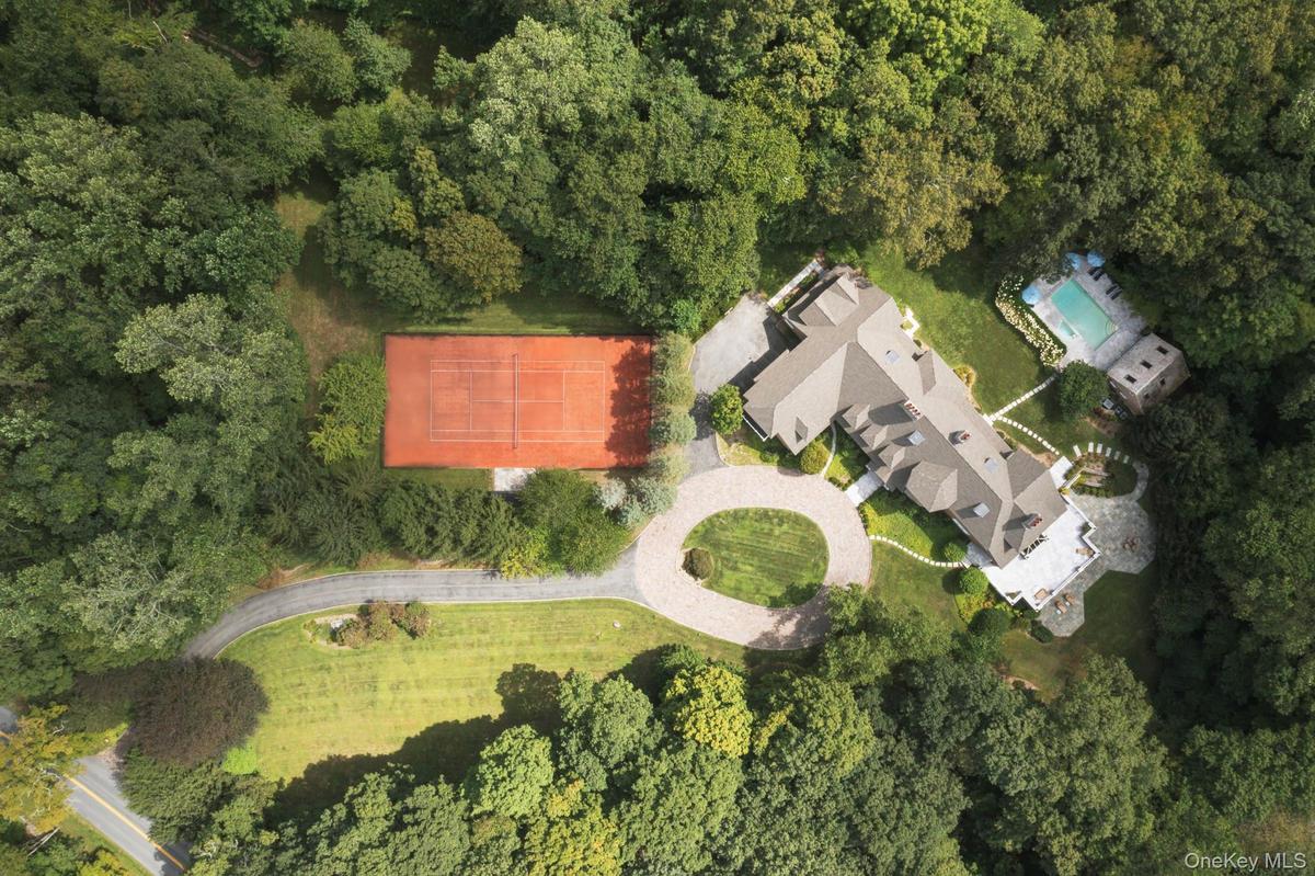 Aerial view of property's location with a forest