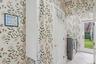 Bathroom featuring wallpapered walls, light tile patterned floors, and washing machine and dryer