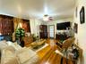 Living area featuring wood-type flooring, crown molding, and a ceiling fan