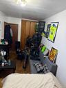 Bedroom featuring dark wood-style floors and a closet