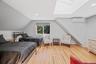 Bedroom with light wood finished floors, vaulted ceiling, recessed lighting, a skylight, and a wall unit AC