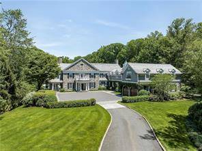 Set on 10 beautifully landscaped private acres, with heated pool and spa, pool house, tennis court with basketball court and pavilion with outdoor fireplace, and 7 car garage, including hydraulic ...