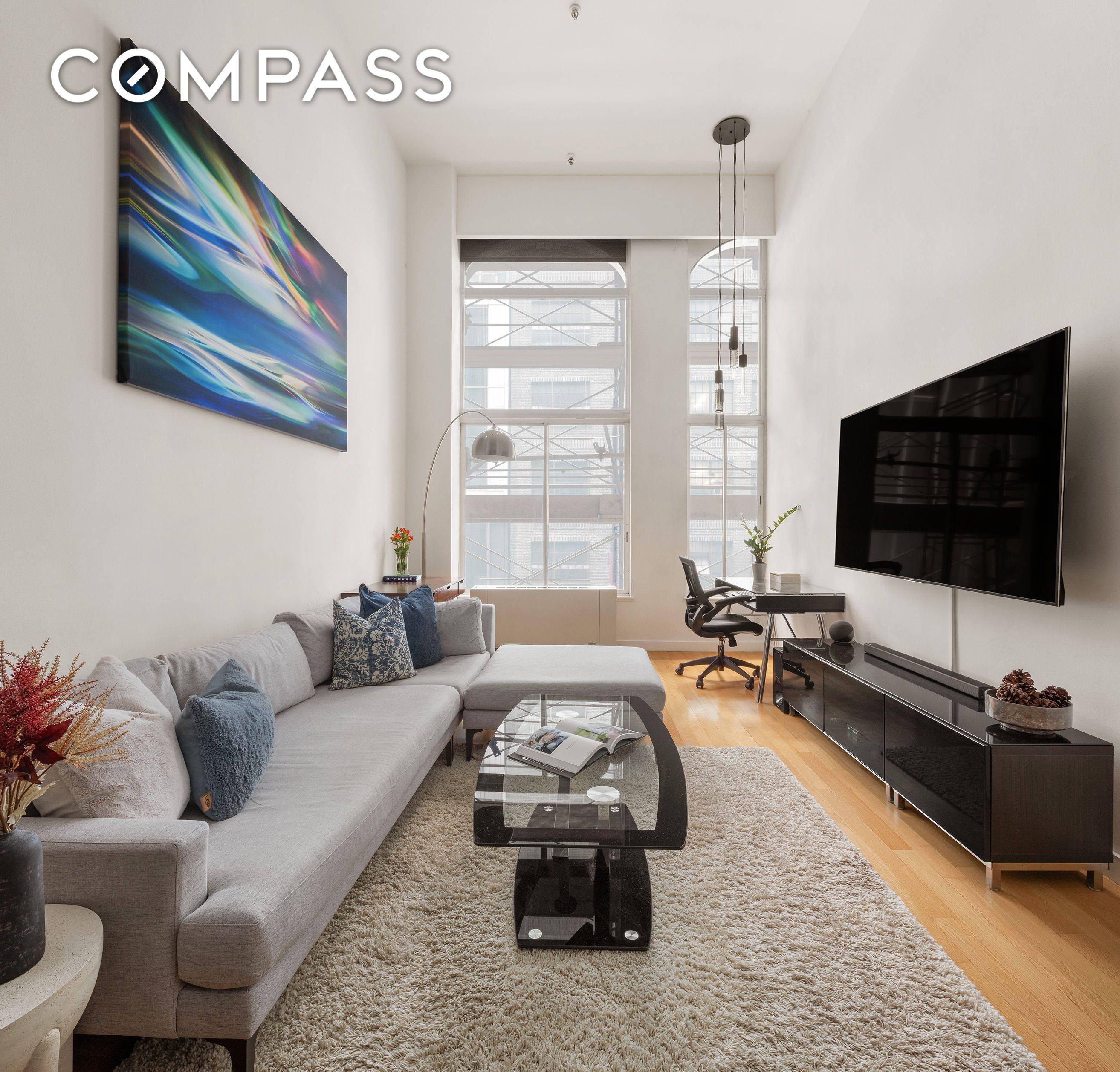 Welcome to Unit 309 at 67 East 11th Street a stunningly renovated one bedroom loft with southern exposure and 16 ft ceilings, once prominently featured in Dwell Magazine.