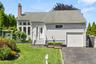 Exterior featuring light gray siding, a single-car garage