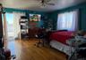 Bedroom featuring ceiling fan and hardwood / wood-style floors