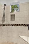 Primary bathroom with dual vanities, spa tub, toilet closet and walk-in shower
