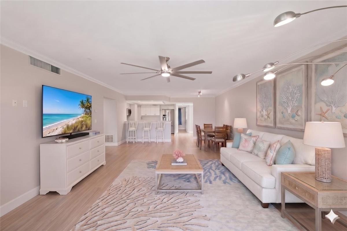 Virtually staged living area with eat in dining area.