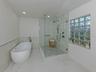 Enjoy the large soaking tub or glass enclosed shower in the primary bath