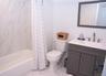 Full bath with shower / bath combo with shower curtain and vanity