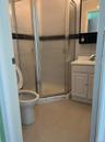 Full bathroom featuring vanity, tile patterned floors, a stall shower, and toilet