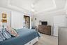 Primary Bedroom Featuring a Coffered Ceiling and Crown Molding