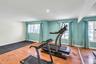 Room featuring light wood-finish flooring, recessed lighting, and a full mirrored wall