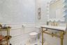 1/2 bathroom with boiserie and wall paper.