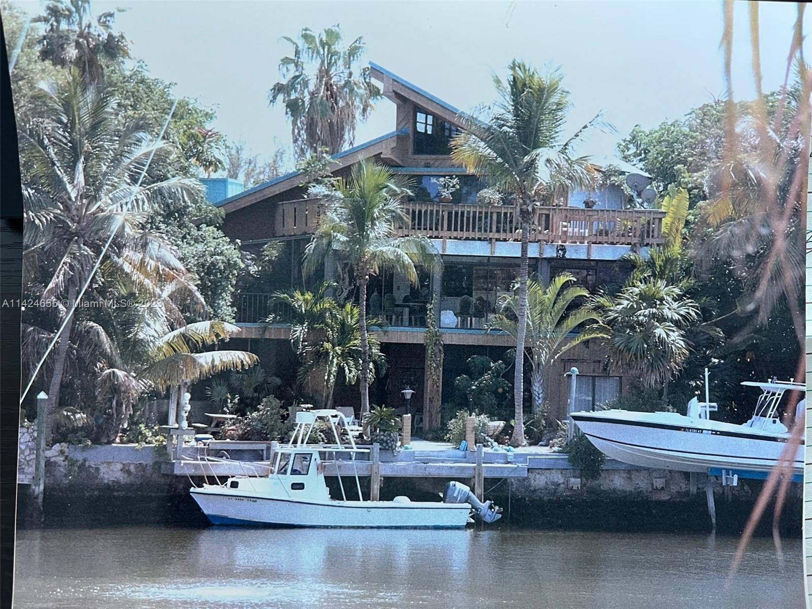 Large 3 story, Boater's Paradise home, located inside gated community of Plantation Lakes Estate with direct lagoon water views and ocean access for large boat.