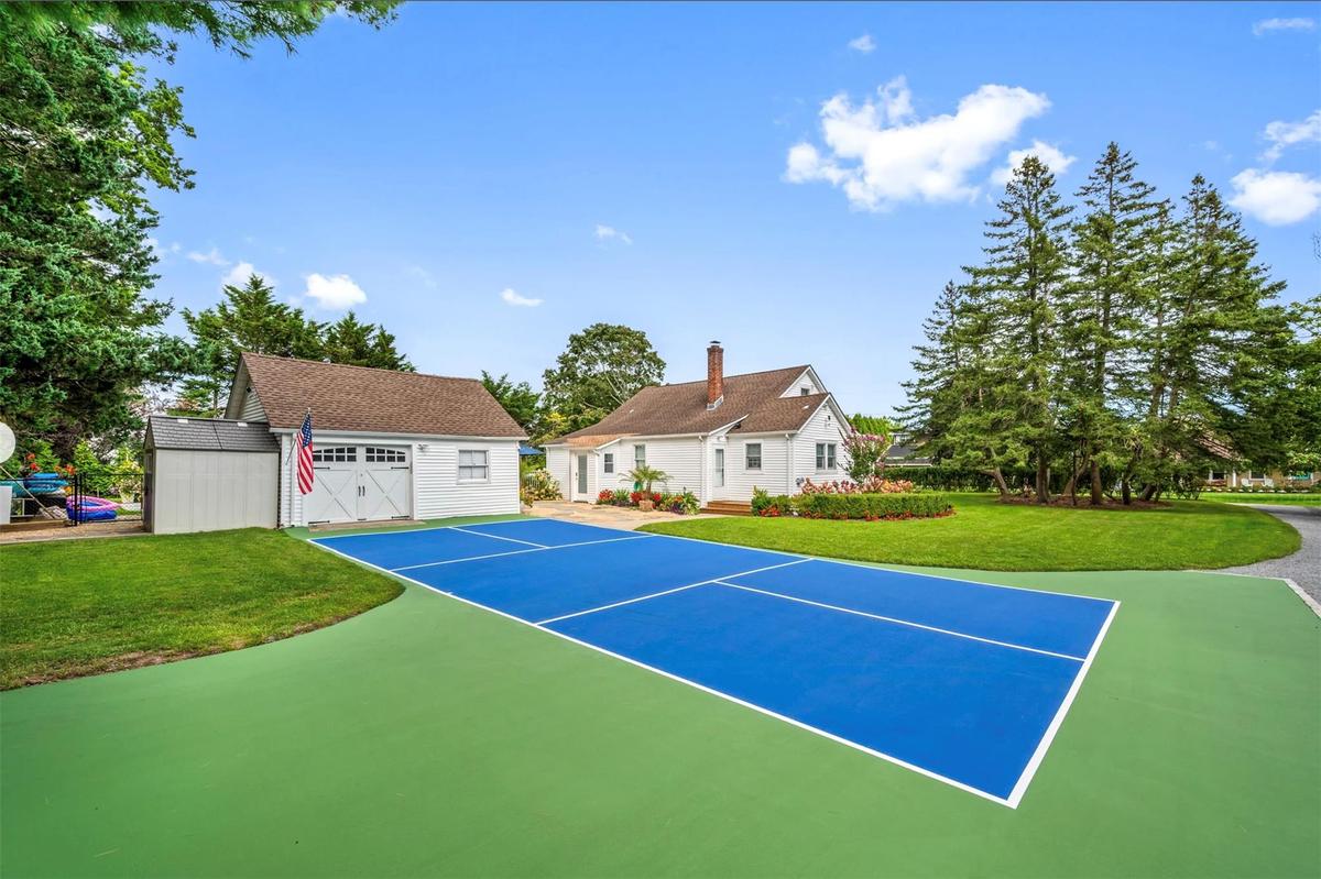 View of sport court with an outbuilding and a lawn