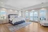 Primary Ensuite Bedroom and balcony with sweeping open bay views