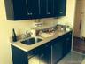 Kitchen with blue cabinets and light stone counters