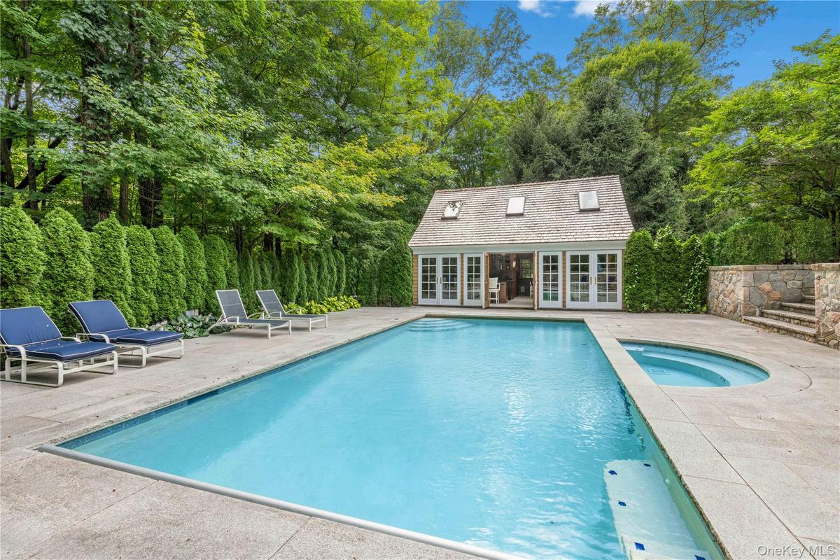 View of pool with an exterior structure, an outdoor structure, a patio, and a pool with connected hot tub