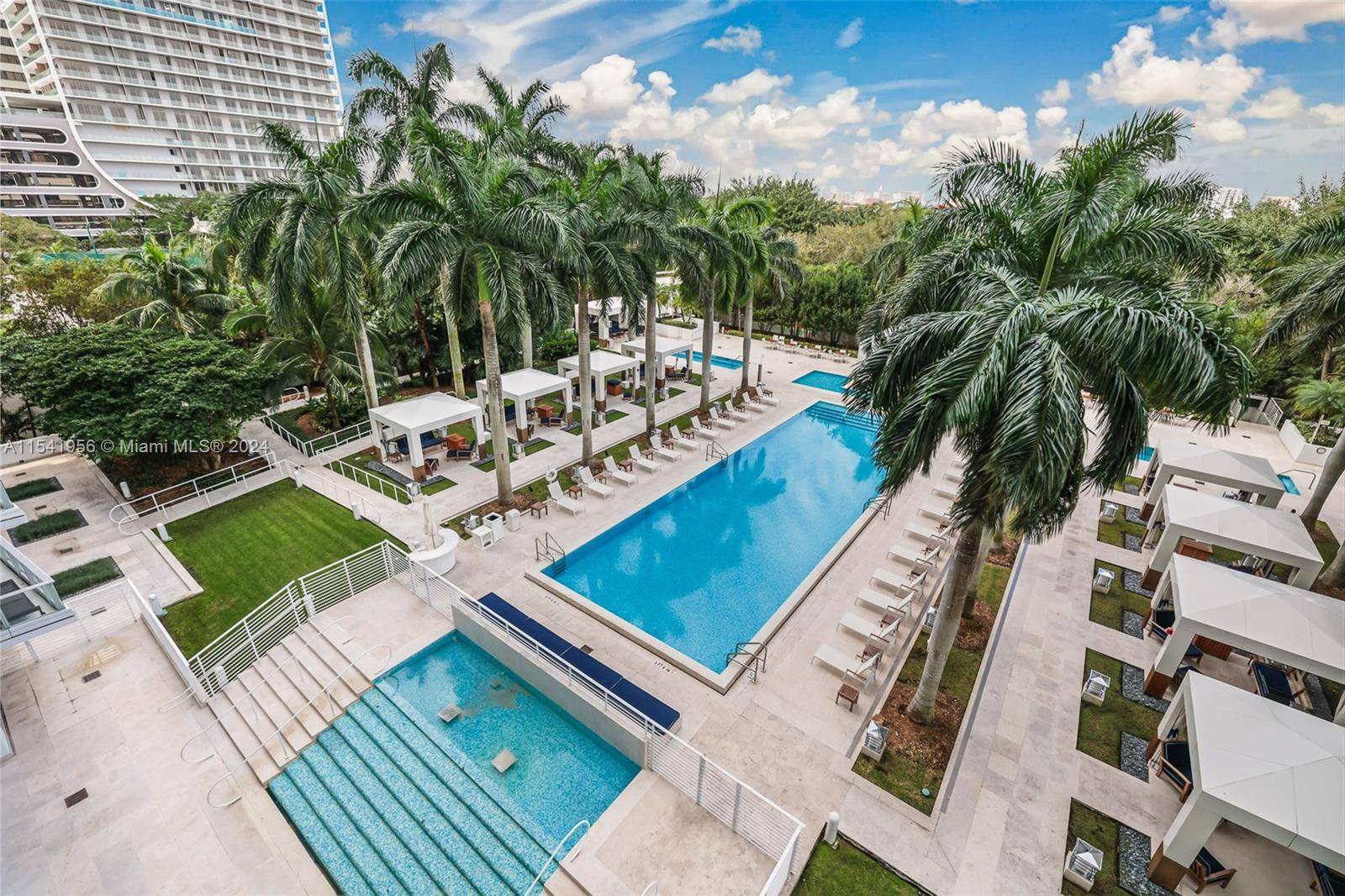 This spacious unit features a split floor plan with floor to ceiling glass that floods each room w natural light and breathtaking views of the palm lined, resort style pool ...