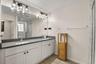 Primary en-suite bathroom featuring dual vanities, generous counter space, and modern finishes.