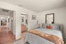 Bright guest bedroom offering comfortable accommodations for family or visitors