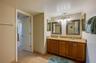 A wider view of the ensuite shows the thoughtful layout and bright lighting, ideal for daily routines.