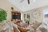 Living area featuring wood finished floors, lofted ceiling, a ceiling fan, and recessed lighting