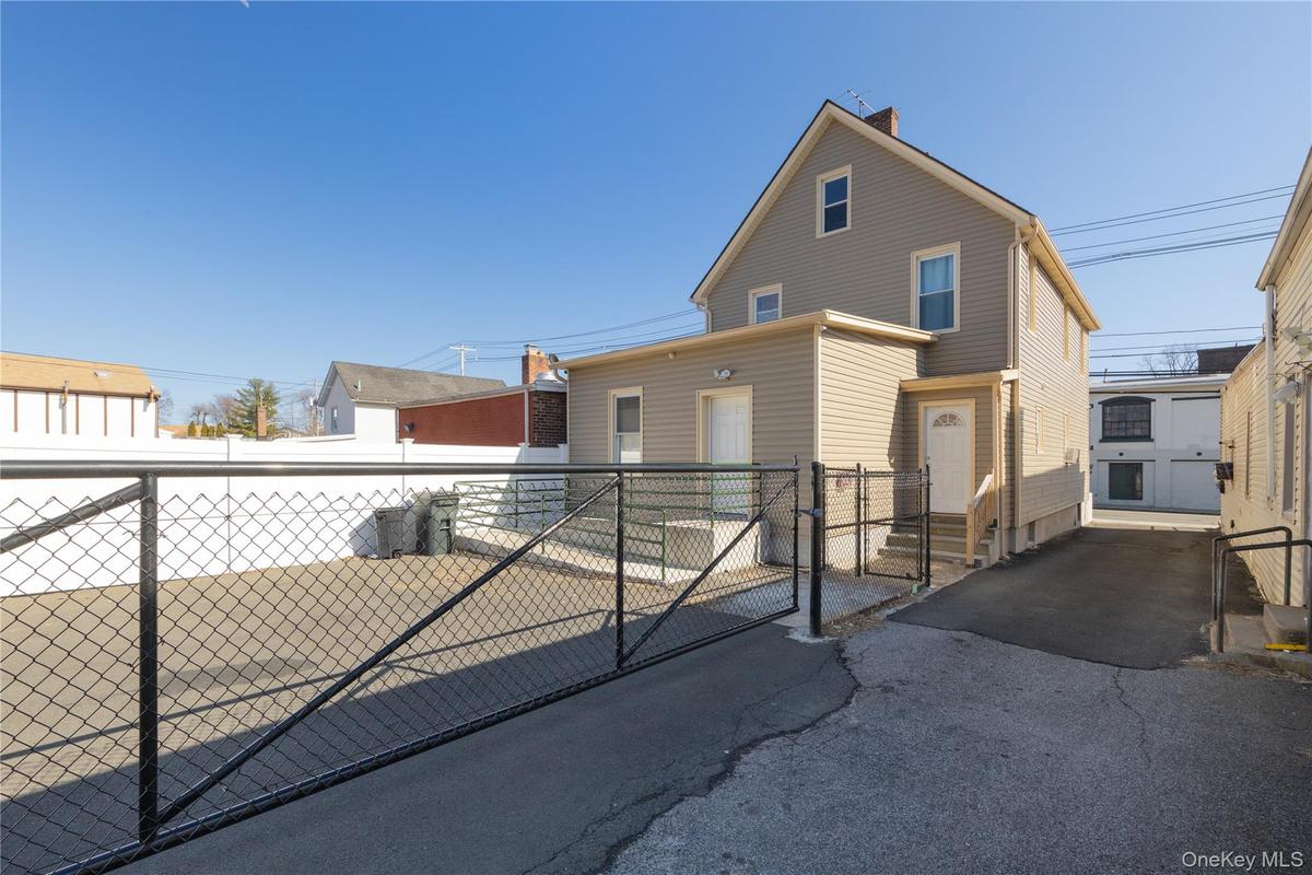 View of front of house featuring a gate