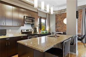Welcome to Park City Lofts Unit 3M, an updated end unit condo with exposed brick details in a pet friendly elevator building !