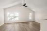 Level Three: Living room featuring Vaulted Ceiling