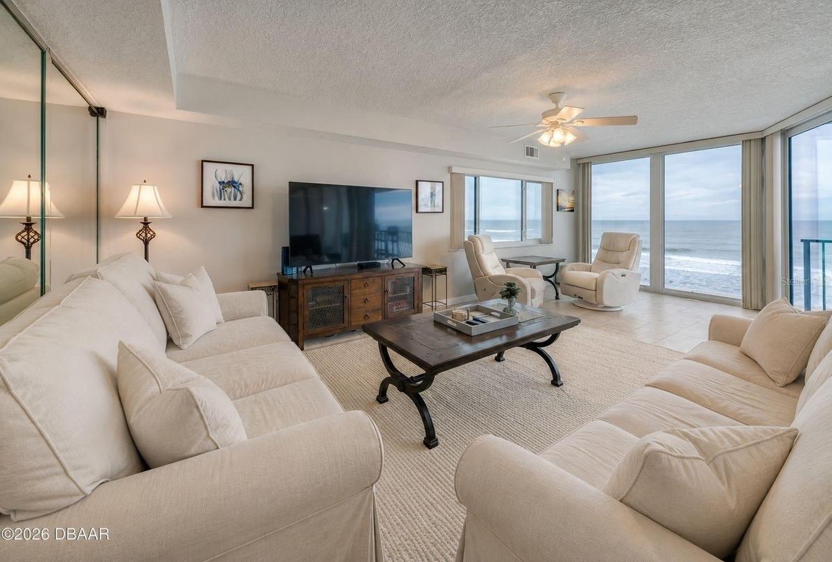 The living area features full-length windows with unobstructed ocean views and access to the balcony an ideal setting for relaxing or hosting guests.