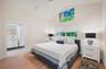 The primary suite has a king bed, custom artwork and ensuite bathroom